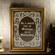 Load image into Gallery viewer, May include: A gold framed mirror with a decorative border. The mirror reflects a candle and a lamp. The mirror has a quote inside: 'In a world full of Mondays, be a Wednesday.'