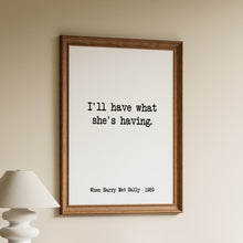 Load image into Gallery viewer, I'll have what she's having When Harry Met Sally 1989 movie quote in black typewriter lettering on a white background in a wooden frame