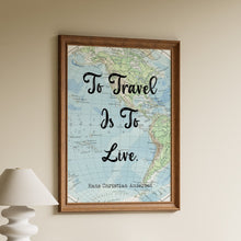 Load image into Gallery viewer, To Travel Is To Live by Hans Christian Andersen in bold black script over a vintage blue and green world map in a wooden frame