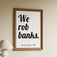 Load image into Gallery viewer, We rob banks Bonnie and Clyde 1967 movie quote in bold black retro lettering on a white background in a wooden frame