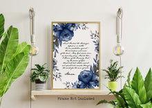 Load image into Gallery viewer, Saint Michael the Archangel prayer print on a white background with a cursive font in a handwritten style and dark blue watercolor flowers surrounding the text. The print is displayed in a gold frame on a shelf, the frame is not included.