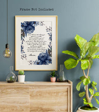 Load image into Gallery viewer, Saint Michael the Archangel prayer print on a white background with a cursive font in a handwritten style and dark blue watercolor flowers surrounding the text. The print is displayed in a wooden frame, the frame is not included.
