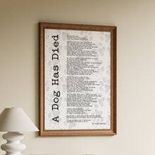 Load image into Gallery viewer, A Dog Has Died poem by Pablo Neruda in black typewriter lettering over a soft grey paw print background in a wooden frame

