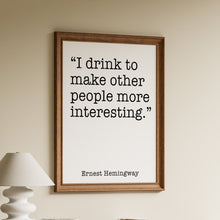 Load image into Gallery viewer, Ernest Hemingway drinking quote print reading “I drink to make other people more interesting” in black typewriter text
