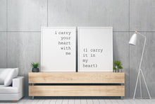Load image into Gallery viewer, May include: Two white framed prints with black text on a white background. The text on the left print reads "i carry your heart with me". The text on the right print reads "(i carry it in my heart)". The prints are hanging on a gray wall above a wooden shelf with two potted plants.
