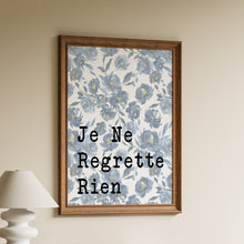 Load image into Gallery viewer, Je Ne Regrette Rien French quote in black typewriter lettering on a blue watercolour floral background in a wooden frame
