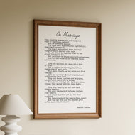 On Marriage by Kahlil Gibran in black typewriter lettering with a script title on a white background in a wooden frame