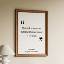Load image into Gallery viewer, Oscar Wilde quote we are all in the gutter but some of us are looking at the stars, in black typewriter lettering with large quotation marks
