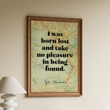 Load image into Gallery viewer, Framed John Steinbeck quote print "I was born lost and take no pleasure in being found" over a vintage world map
